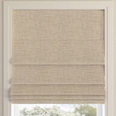 a beige roman blind in a window