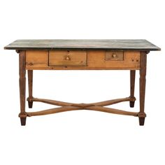 an old wooden table with two drawers on one side and three drawers on the other