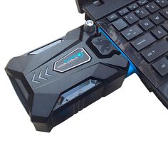 an open laptop computer sitting on top of a black and blue keyboard with the words russian above it