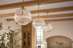 three glass globes hanging from the ceiling in a kitchen