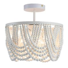 a white chandelier with beads hanging from it's ceiling fixture, on a white background