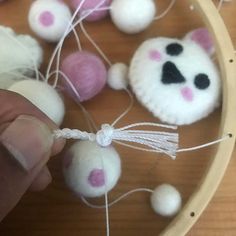 someone is making some balls with yarn