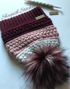 a crocheted hat with a pom - pom attached to it