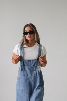 Frankie Denim Overalls are crafted from washed denim for a stylish, weathered look. Featuring an oversized and loose fit with adjustable straps and distressed details, these overalls are designed to provide a comfortable, personalized fit. Model Measurements: Hips 34” Waist 25” Bust 32” Height 5’6.5, wearing a size small Material: 100 Cotton Measurements XS: Hips: 42"| Length: 44" (taken from top of front of overalls to ankle cuff) S: Hips: 42"| Length: 44.5" (taken from top of front of overalls Bridesmaid Tops, Washed Denim, Denim Overalls, Man Swimming, Romper Pants, Trending Dresses, New Arrival Dress, Summer 2024, To Miss