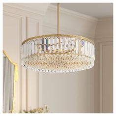 a chandelier hanging from the ceiling in a room with white walls and gold trim