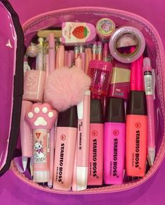 a pink case filled with lots of different types of makeup