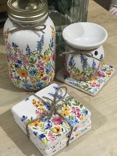 three pieces of pottery sitting on top of a table next to a jar and bowl