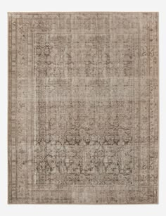 an antique style rug in beige and brown tones with a faded design on the middle