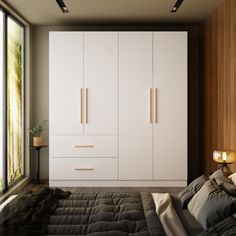 a bedroom with white cabinets and black bedding