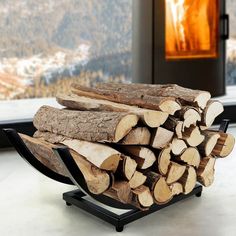 a stack of firewood sitting on top of a table next to a glass window