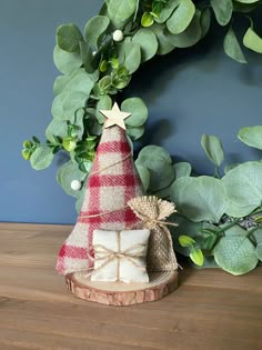 a small christmas tree sitting on top of a wooden table