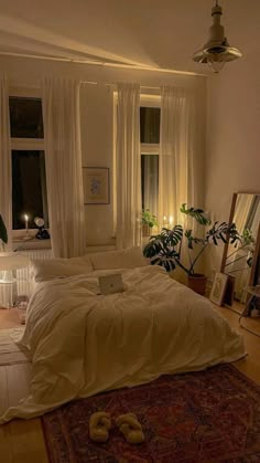 a bed room with a neatly made bed and lots of plants on the wall next to it