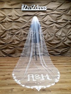 a wedding veil is displayed in front of a backdrop