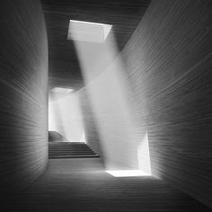 the light shines through the windows in this black and white photo, as it casts shadows on the wall