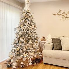 a living room with a white christmas tree