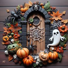 a door decorated with halloween decorations and pumpkins on a wooden surface in the shape of a wreath