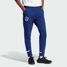 adidas Shop the LA Galaxy Designed for Gameday Travel Pants - Blue at adidas.com/us! See all the styles and colors of LA Galaxy Designed for Gameday Travel Pants - Blue at the official adidas online shop. Blue Sporty Sweatpants With Three Stripes Branding, Sporty Blue Sweatpants With Three Stripes Branding, Blue Adidas Bottoms For Jogging, Sporty Blue Joggers With Three Stripes Branding, Blue Adidas Athleisure Pants, Sportswear Bottoms With Pockets For Sports Events, Casual Sports Bottoms With Three Stripes, Casual Three Stripes Bottoms For Sports Events, Adidas Three Stripes Bottoms For Sports Events