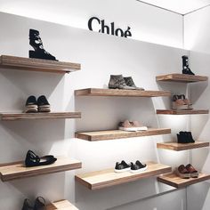 several shelves with shoes on them in front of a sign that says chiloa