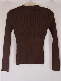 Effortless and classic brown ribbed knit top with stretchy material, long sleeves, v-neckline, and collar detail. details & fit: fits slightly small. 70% viscose, 30% polyester measurements: small: bust 26"/ waist 18"/ length 21" medium: bust 28"/ waist 20"/ length 21.5" large: bust 30"/ waist 22"/ length 22" model details: model is 5'7" and wearing size medium Brown Long Sleeve Sweater With Ribbed Neckline, Brown Knit Sweater With Ribbed Neckline, Classic Stretch Brown Sweater, Brown Stretch Turtleneck Sweater, Chic Brown Ribbed Knit Top, Stretch Fine Knit Brown Sweater, Stretch Brown Fine Knit Sweater, Brown Long Sleeve Knit Top For Spring, Brown Long Sleeve Top With Ribbed Collar