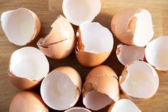 several broken eggs sitting on top of a wooden table