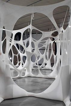 an art installation in the middle of a building with white and blue designs on it