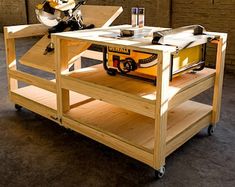 a workbench with tools on it in the middle of a room filled with wood