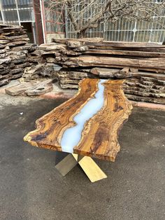 a table made out of wood with blue water in the center and gold metal legs