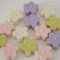 many small candles are arranged in the shape of flowers