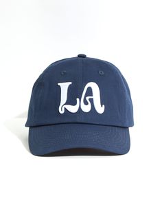 Details Navy blue hat with white LA logo embroidery Chance logo embroidery on back 100% Cotton 6 panel hat Woven eyelets Strap-back closure with metal triglide Navy Blue Hat, Christian Hats, White Ferrari, Leon Dore, Best Caps, Spreading Positivity, Event Branding, Classic Hats, Hat Embroidery