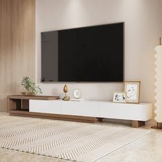 a large flat screen tv mounted to the side of a wall in a living room