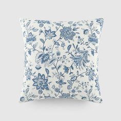 a blue and white pillow with flowers on it