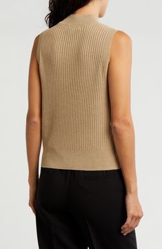 Knit from soft yarns, a lightweight, refined mock-neck sweater is a luxe layering option when the temperature starts to drop. Mock neck Sleeveless 92% polyester, 8% metallic fibers Machine wash, dry flat Imported Sleeveless Textured Knit Top For Work, Fall Ribbed Vest For Layering, Spring Turtleneck Knit Top For Layering, Turtleneck Knit Top For Spring Layering, Textured Knit Stretch Sweater Vest, Knit Tank Top For Layering With Ribbed Neckline, Versatile Stretch Sweater Vest For Layering, Chic Spring Knit Mock Neck Top, Fall Layering Pointelle Knit Sweater Vest