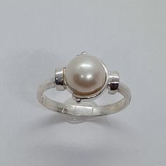 This handmade, beautiful Pearl ring has been expertly crafted in warm 925 sterling silver , authentic pearl . This gorgeous ring will make a great special occasion/ birthday gift. All of my jewelry is handmade from scratch, one item at a time as I like to make sure I am producing a high quality item. A tracking shipping number will be provided to you once the ring has been shipped. Pearl measurements:  White Pearl: 7.7 mm Ring size : 6 3/4 Ring Weight: 2.6 grams Ring Band at smallest point: 2.23 White Sterling Silver Pearl Ring Gift, Classic Sterling Silver Pearl Drop Ring, Classic White Pearl Ring For Gifts, Pearl White Sterling Silver Ring For Gift, Handmade Classic Pearl Ring As A Gift, Hallmarked Open Pearl Ring For Gifts, Handmade Classic Pearl Ring As Gift, Handmade Classic Pearl Ring For Gift, Hallmarked Open Pearl Ring As Gift