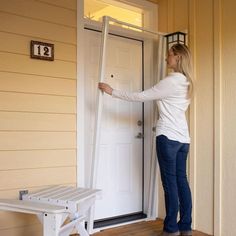 a woman standing in front of a white door