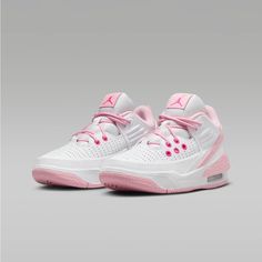 a pair of white and pink shoes on a gray background