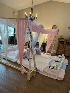 a canopy bed with pink and white drapes