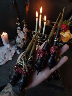 a person holding some candles in their hand