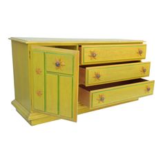 a yellow dresser with three drawers on it