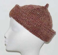 a white mannequin head wearing a brown knitted hat