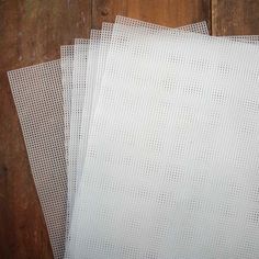 three pieces of white paper on top of each other