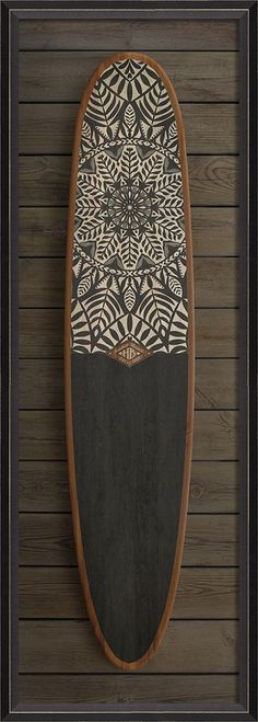 a surfboard mounted to the side of a wooden wall with an intricate design on it