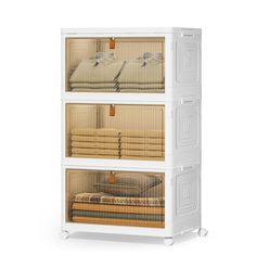 three shelves filled with folded towels and linens on top of each other in front of a white background