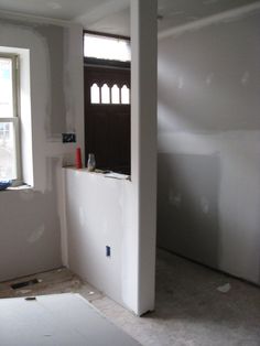 an empty room is being remodeled with white walls and wood trim on the windowsill