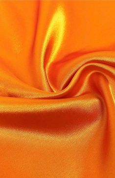 INFORMATION: This beautiful Stretch Charmeuse Sayin Fabric has a beautiful smooth shiny satin side with a modest matte finish on the back. The fabric is tightly woven and has a light 2-way vertical stretch, making it extremely durable. In addition, our stretch charmeuse is approximately 7 ounces per linear yard which is a better construction than most standard stretch charmeuse fabrics. This heavier gsm (grams per square meter) gives the fabric a richer feeling and a better hold when draping. Th Pantone Orange, Couture Gown, Orange Satin, Orange You Glad, Shiny Fabric, Net Fabric, Orange Fabric, Couture Gowns, Stretch Satin