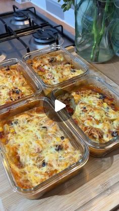 four casseroles sitting on top of a wooden counter