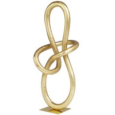 a gold sculpture with an intertwined knot on it's end, against a white background