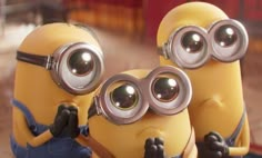 two minion characters are looking through binoculars