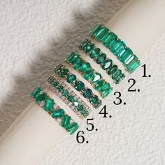 Crafted to perfection, our Lab Grown Emerald Eternity Bands stand out as stunning pieces of elegance. Encased in a fine Gold Band, each ring features a mesmerizing Green Emerald at its center, exuding a sense of sophistication and charm. These Stackable Rings offer versatility, allowing you to mix and match for a personalized touch, perfect for daily wear or special occasions. Whether worn alone or as part of a bridal jewelry set, these bands add a touch of luxury to any ensemble. Elevate your s Luxury Channel Set Emerald Engagement Ring, Luxury Green Eternity Band For Anniversary, Emerald Stackable Ring, Emerald And Diamond Eternity Band, Emerald Anniversary Ring, Emerald Infinity Band, Green Baguette Cut Stackable Rings, Stackable Emerald Jewelry For Anniversary, Stackable Emerald Cubic Zirconia Ring In Fine Jewelry Style