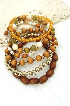 Exude bohemian flair when you wear this wooden bead stretch bracelet set. DIMENSION clasp: Stretchable metal finish: Gold Plating product: Lead & Nickle Compliant anti-tarnish: Double E-coating Bohemian Gold Beaded Bracelet With Wooden Beads, Bohemian Wood Beaded Bracelets, Trendy Brown Round Bead Bracelets, Trendy Brown Round Beaded Bracelets, Casual Brown Wooden Jewelry, Bohemian Wooden Bead Bracelets, Bohemian Wood Beaded Jewelry, Brown Beaded Wood Bracelets, Bohemian Gold Stretch Bracelet With Wooden Beads