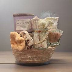 a wicker basket filled with bath items on top of a wooden table